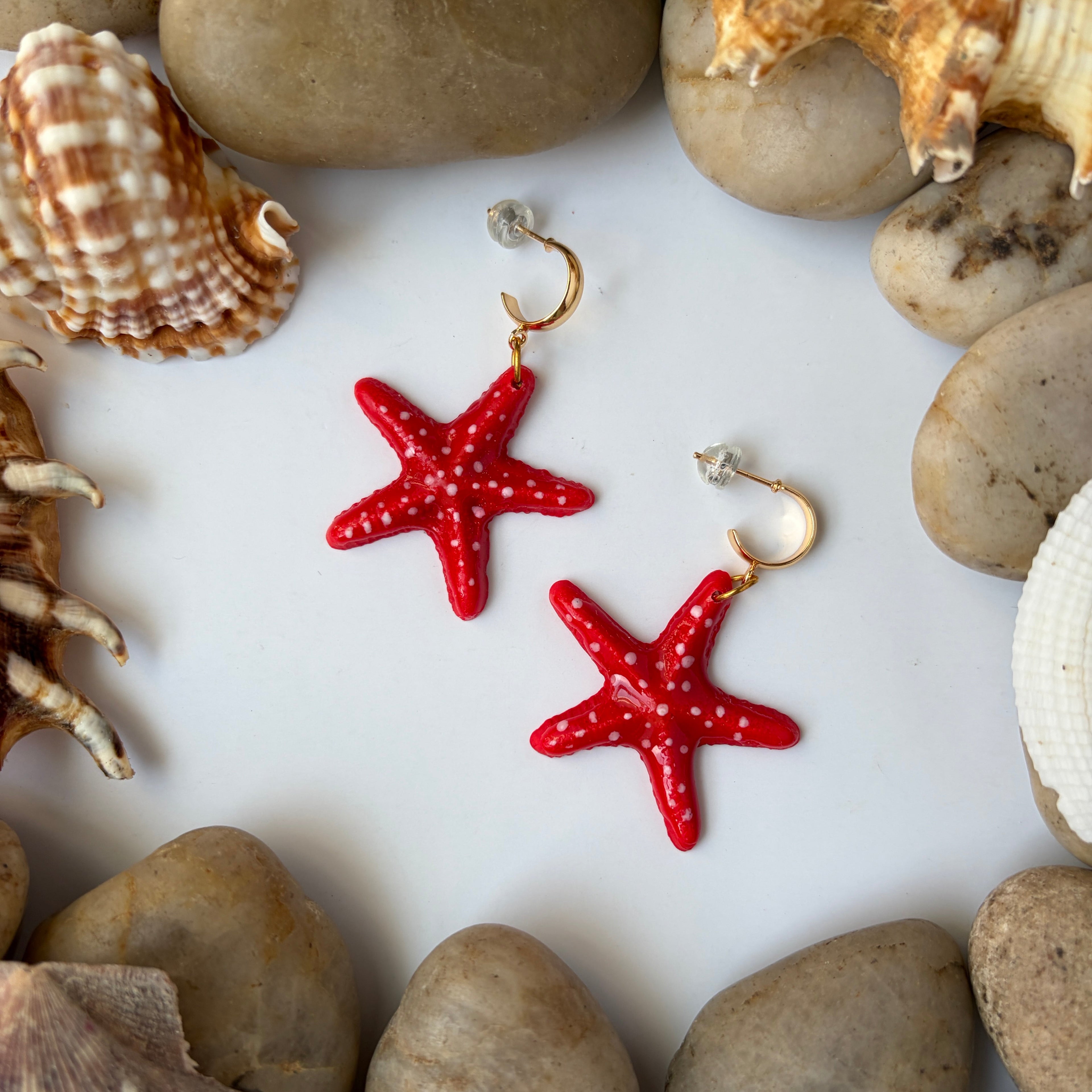 Boucles d’oreilles Étoiles de mer sculptées : étoiles de mer rouge vif posées parmi coquillages et galets